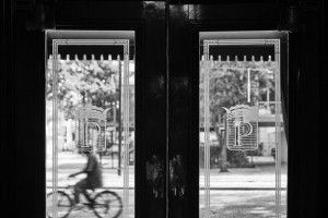 Black and white photo of the front doors of our New Orleans hotel with the letter P on the windows
