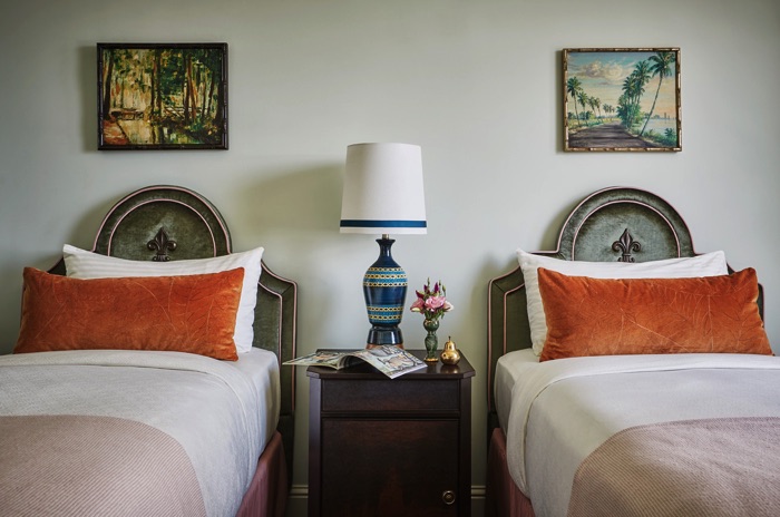 Twin beds with coral and peach bedding at our New Orleans hotel