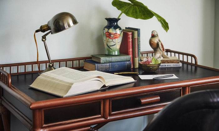 The Clio King Work desk with book and knick-knacks in our New Orleans Garden District hotel