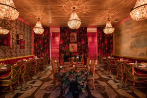 Jack Rose dining area with floral patterns and chandeliers in New Orleans