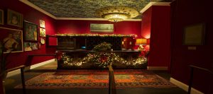 The Pontchartrain Hotel's front desk decorated with garland and wreath for the holidays