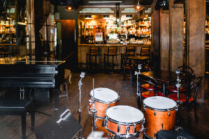 Drumset and small piano overlooking Bayou Bar in New Orleans