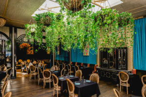 Lush hanging plants on the ceiling of our Garden District restaurant