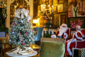 Tabletop Christmas tree with Mr. and Mrs. Claus in the background at Jack Rose