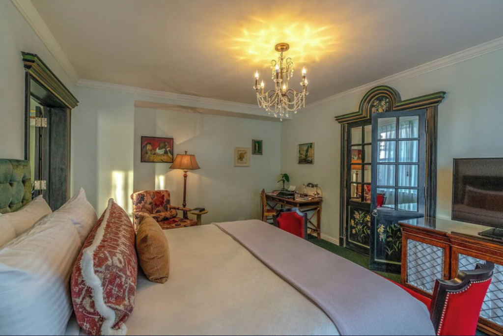 Hotel bedroom with chandelier and French doors