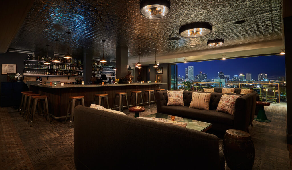 view from inside a rooftop bar overlooking New Orleans skyline